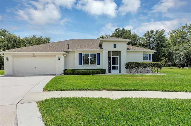 view of front of house with a front yard and a garage