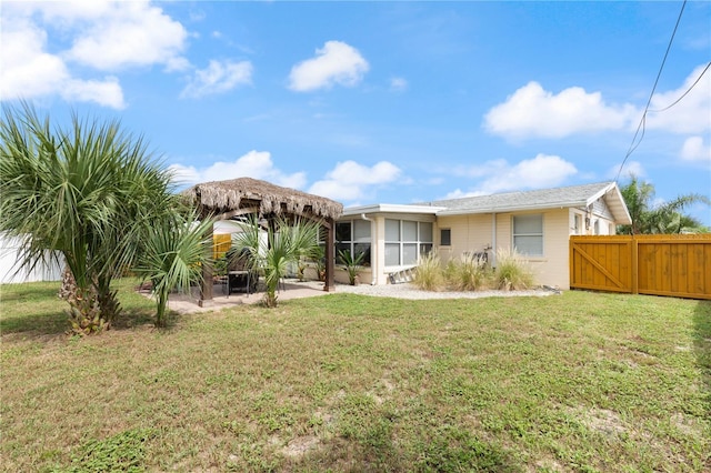 rear view of house featuring a yard