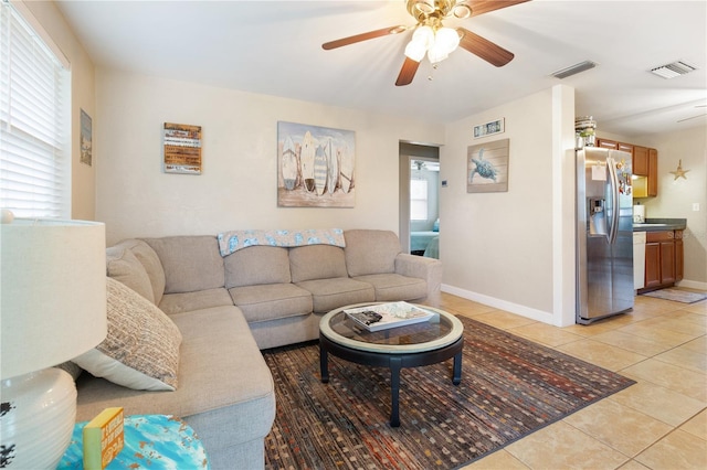 living room featuring light tile patterned floors and ceiling fan