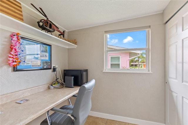 office space featuring light tile patterned floors and a textured ceiling