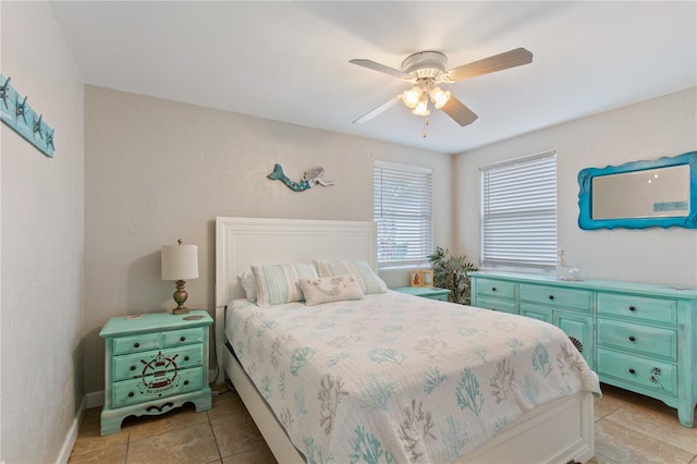 tiled bedroom featuring ceiling fan