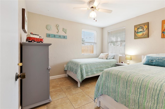 tiled bedroom featuring ceiling fan