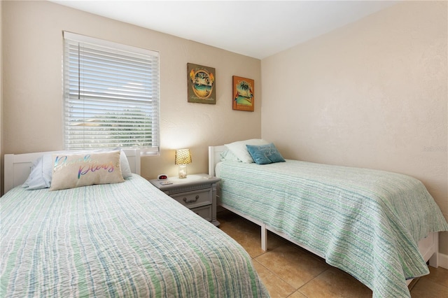 bedroom with light tile patterned floors