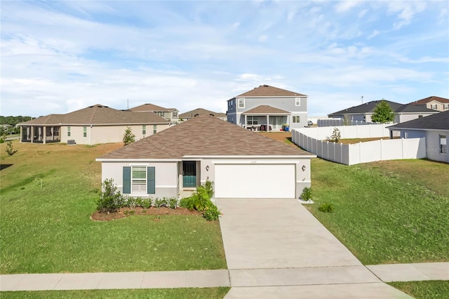 view of front of house with a front yard and a garage