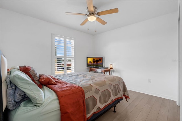 bedroom with wood-type flooring and ceiling fan