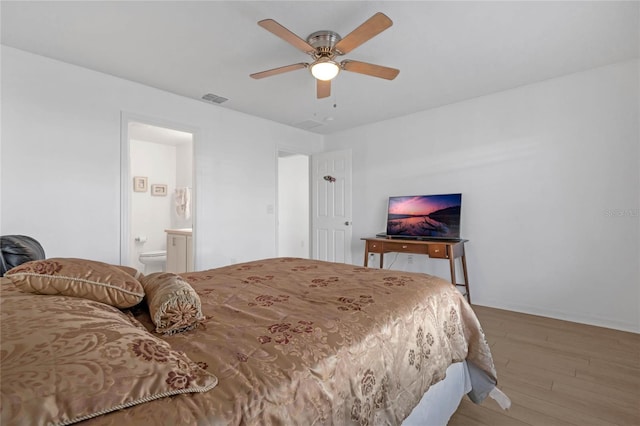 bedroom featuring wood-type flooring, ceiling fan, and connected bathroom