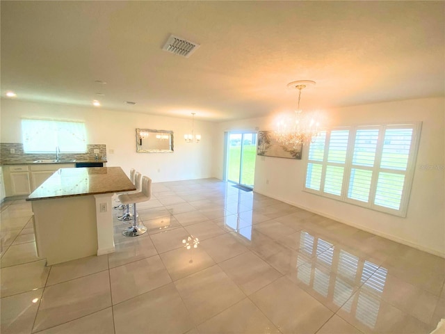 interior space with an inviting chandelier, a wealth of natural light, and sink