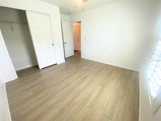 unfurnished bedroom featuring a closet and light hardwood / wood-style floors