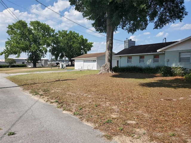 view of front of property with a front yard and a garage