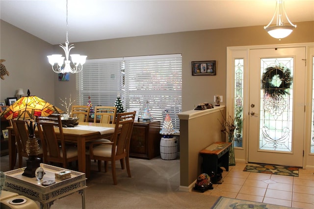 dining area with tile flooring and a notable chandelier