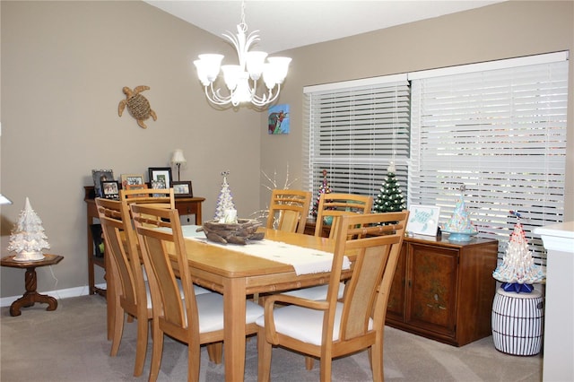 dining area with carpet and an inviting chandelier