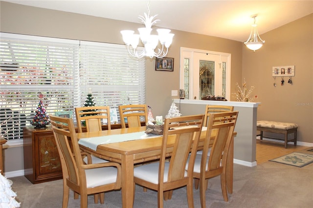 carpeted dining area featuring a notable chandelier