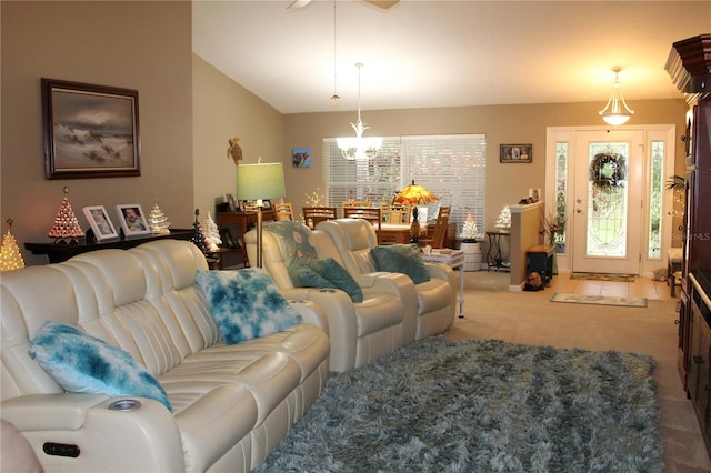 carpeted living room featuring an inviting chandelier and vaulted ceiling