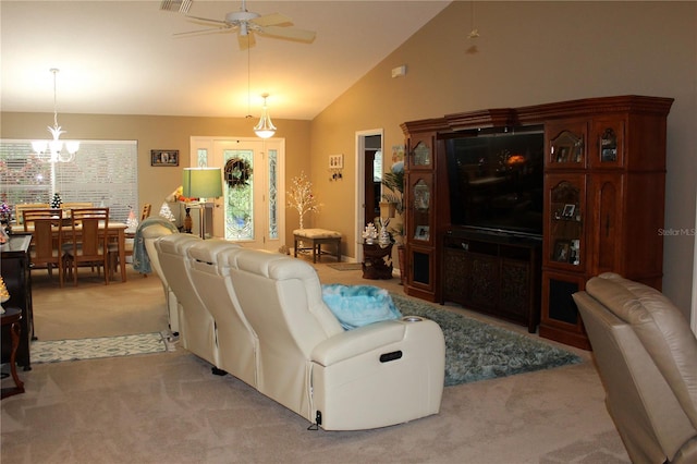 living room featuring a healthy amount of sunlight, ceiling fan with notable chandelier, high vaulted ceiling, and carpet floors