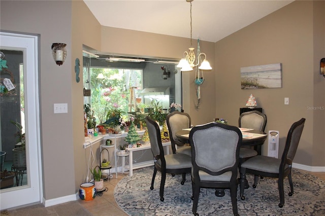 dining space with tile flooring, vaulted ceiling, and a chandelier