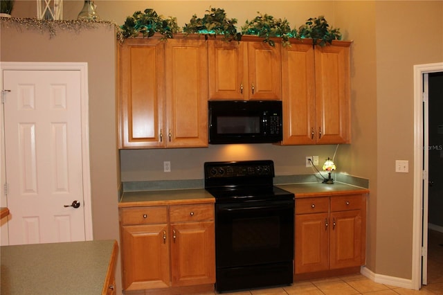 kitchen featuring black appliances and light tile flooring