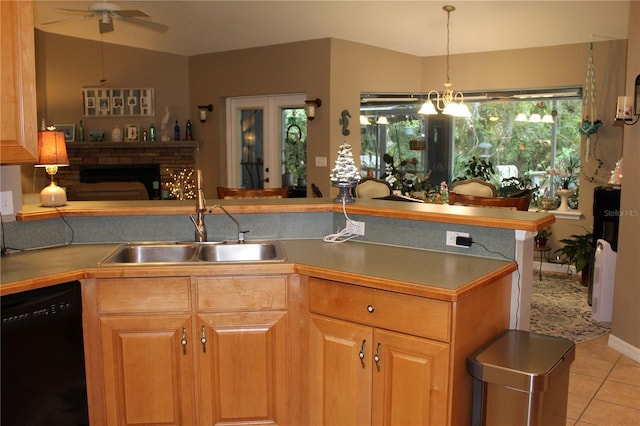 kitchen with ceiling fan, light tile floors, sink, black dishwasher, and plenty of natural light