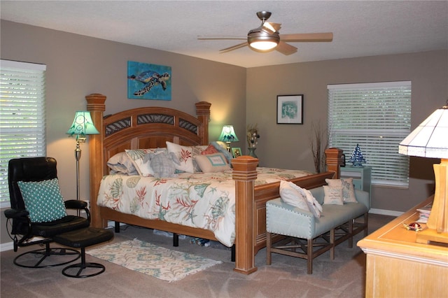 bedroom with carpet, ceiling fan, a textured ceiling, and multiple windows