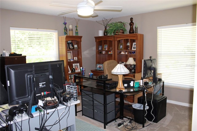 carpeted home office with ceiling fan