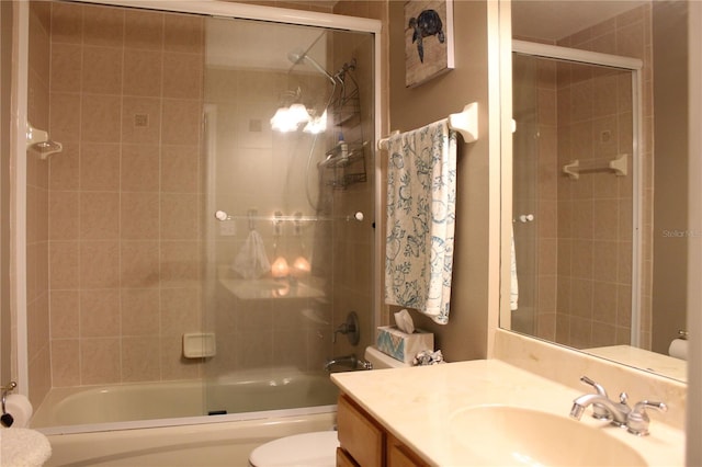 full bathroom with toilet, shower / bath combination with glass door, and large vanity