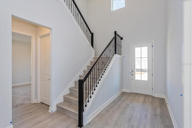 entrance foyer featuring a high ceiling and light wood-type flooring