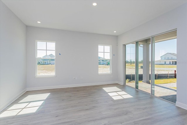 unfurnished room with light hardwood / wood-style floors