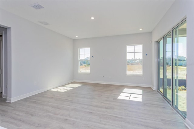 spare room featuring light hardwood / wood-style floors