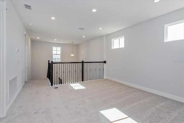 basement featuring light colored carpet and a healthy amount of sunlight