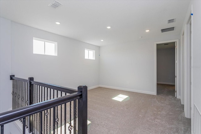 hall featuring light colored carpet