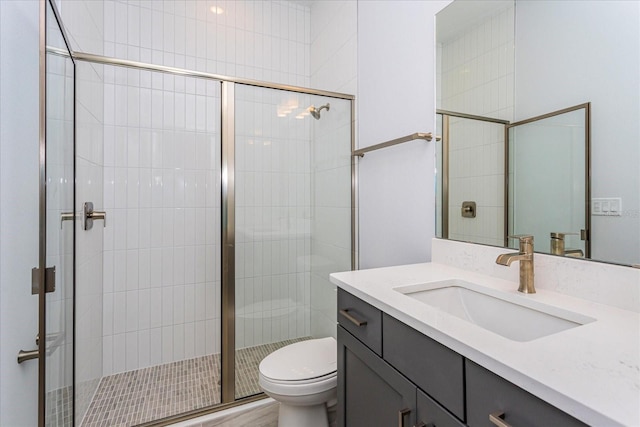 bathroom featuring walk in shower, vanity, and toilet