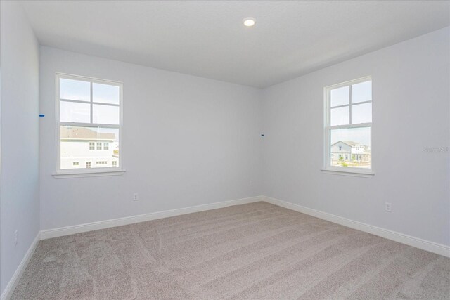 empty room featuring light carpet