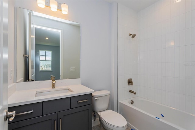 full bathroom with tiled shower / bath, vanity, and toilet