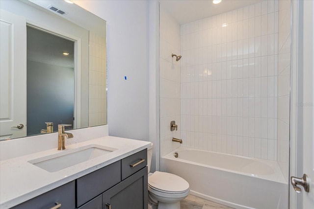 full bathroom featuring vanity, toilet, and tiled shower / bath combo