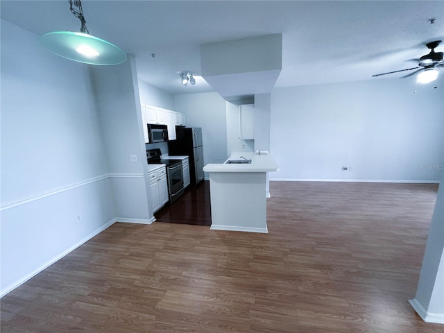 kitchen with white cabinets, refrigerator, dark wood-type flooring, range with electric stovetop, and ceiling fan