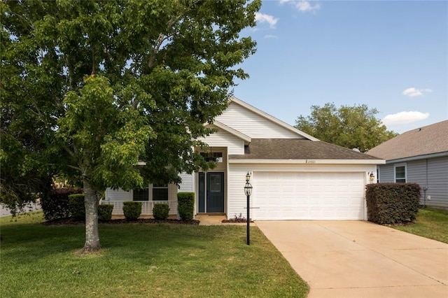 view of front of property featuring a front lawn and a garage