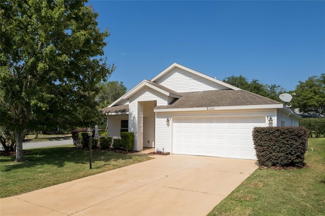 ranch-style home featuring a garage and a front lawn