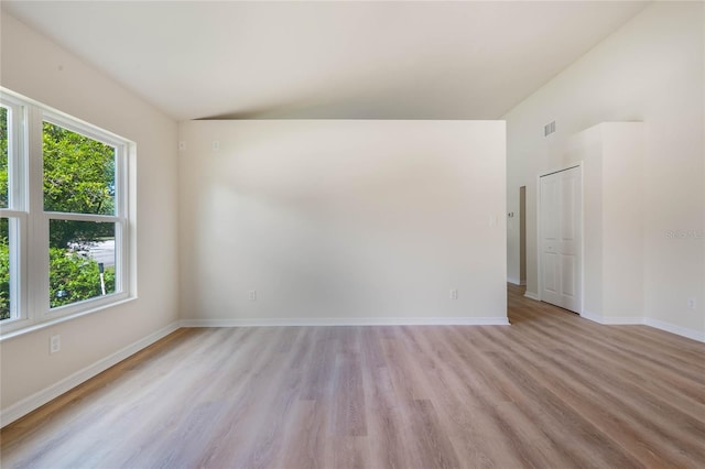 spare room with light wood-type flooring and a wealth of natural light