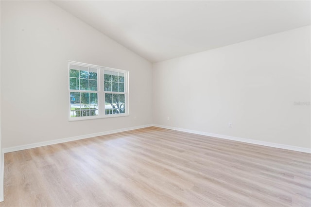 unfurnished room featuring high vaulted ceiling and light wood-type flooring