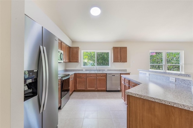 kitchen with sink, appliances with stainless steel finishes, and light tile floors