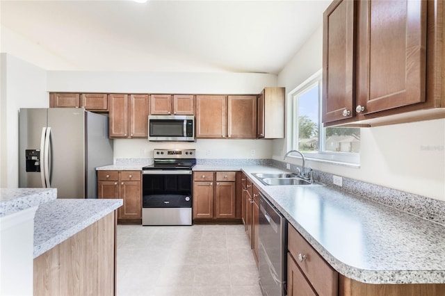 kitchen featuring appliances with stainless steel finishes, light tile floors, and sink