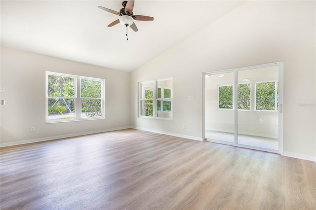 spare room featuring high vaulted ceiling, ceiling fan, and light wood-type flooring