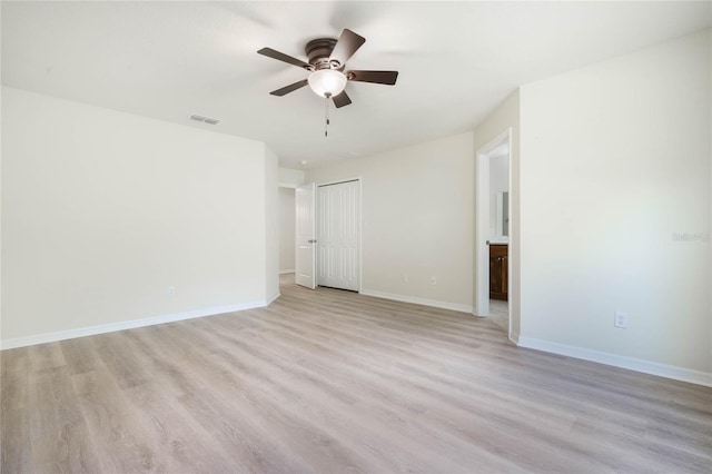 empty room featuring light hardwood / wood-style flooring and ceiling fan