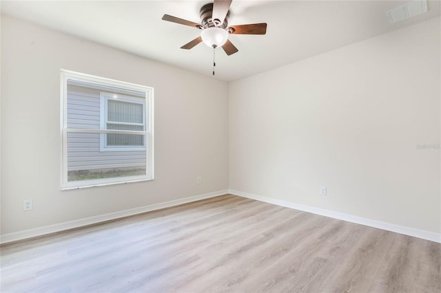 spare room with light hardwood / wood-style flooring and ceiling fan