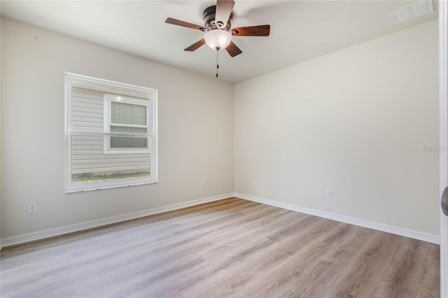 empty room featuring ceiling fan and light wood-type flooring