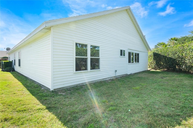 back of property featuring a lawn