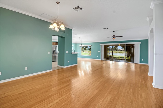 empty room with ceiling fan with notable chandelier, light wood-type flooring, and ornamental molding