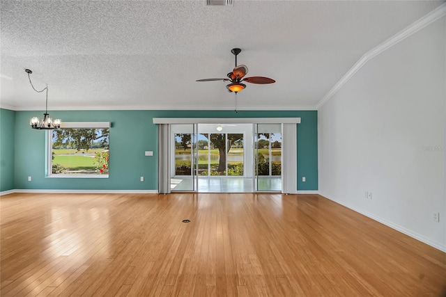 spare room featuring ceiling fan with notable chandelier, a textured ceiling, crown molding, and light wood-type flooring