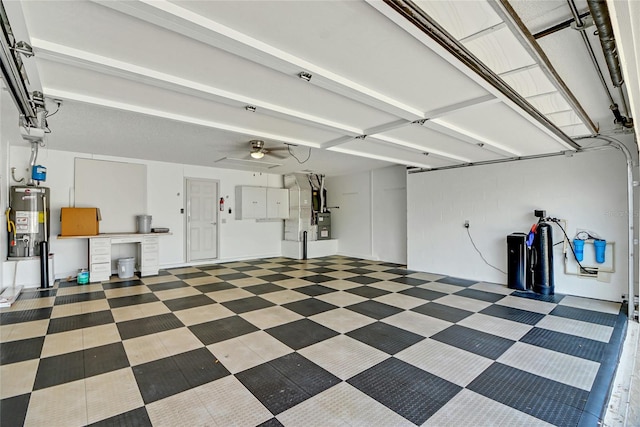 garage with ceiling fan, heating utilities, and gas water heater