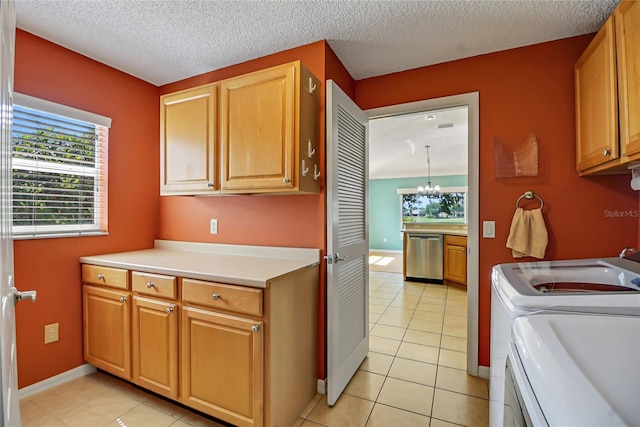 kitchen with washer and dryer, an inviting chandelier, light tile floors, dishwasher, and a textured ceiling