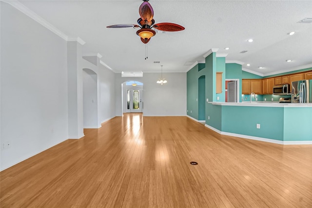 unfurnished room featuring ornamental molding, ceiling fan with notable chandelier, and light wood-type flooring